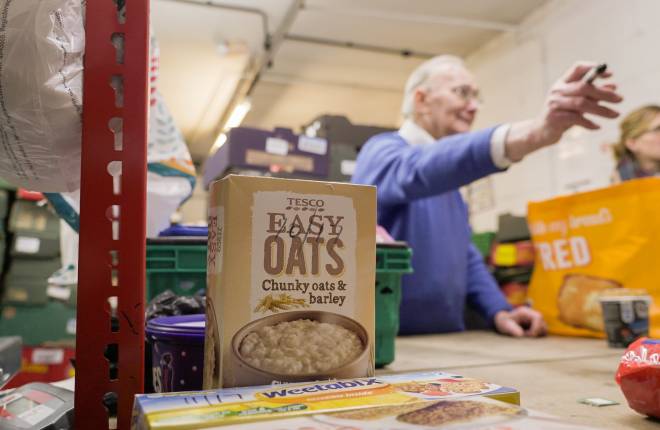 Cereal box in foodbank, volunteers in the background
