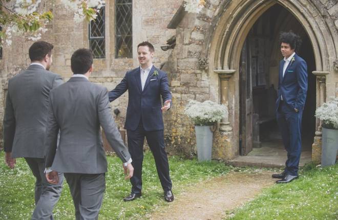 The groom greets the ushers outside church