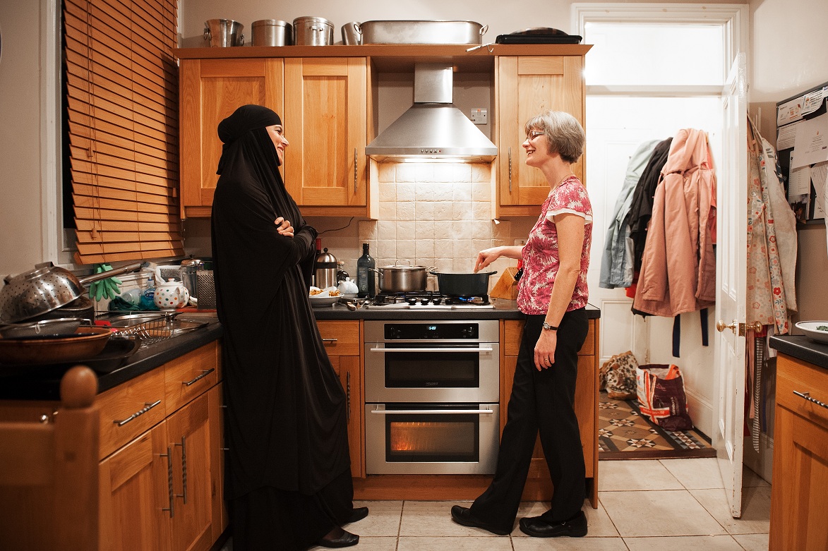 Two women talking in kitchen
