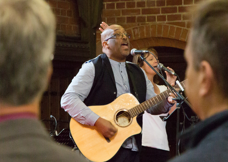 Man playing guitar in church service