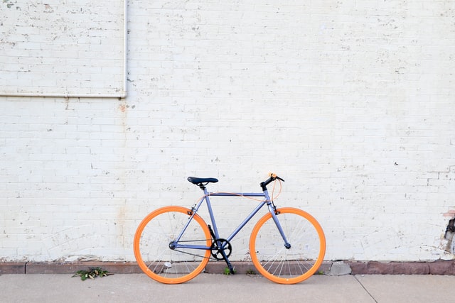 Bike with orange tyres against white wall