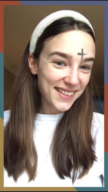 A woman with a virtual Ash cross on her forehead.