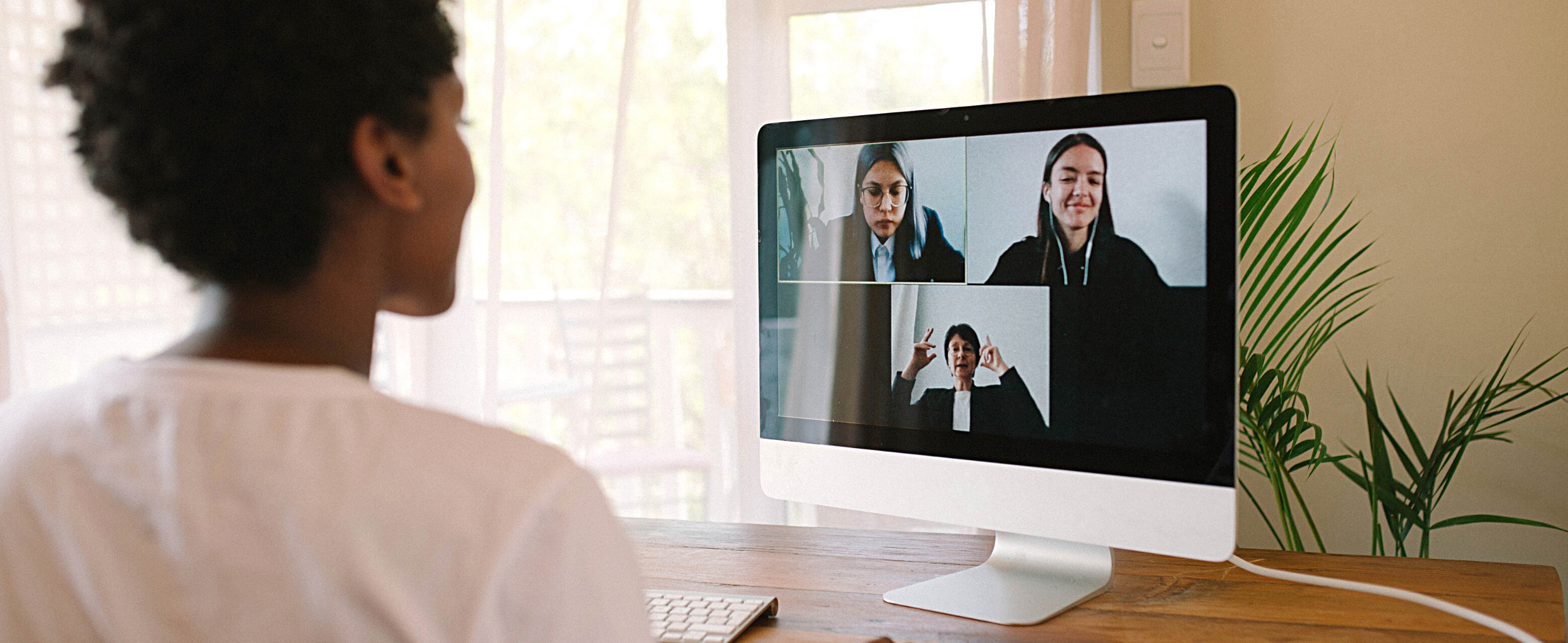 Women participating in a Zoom meeting with three other women