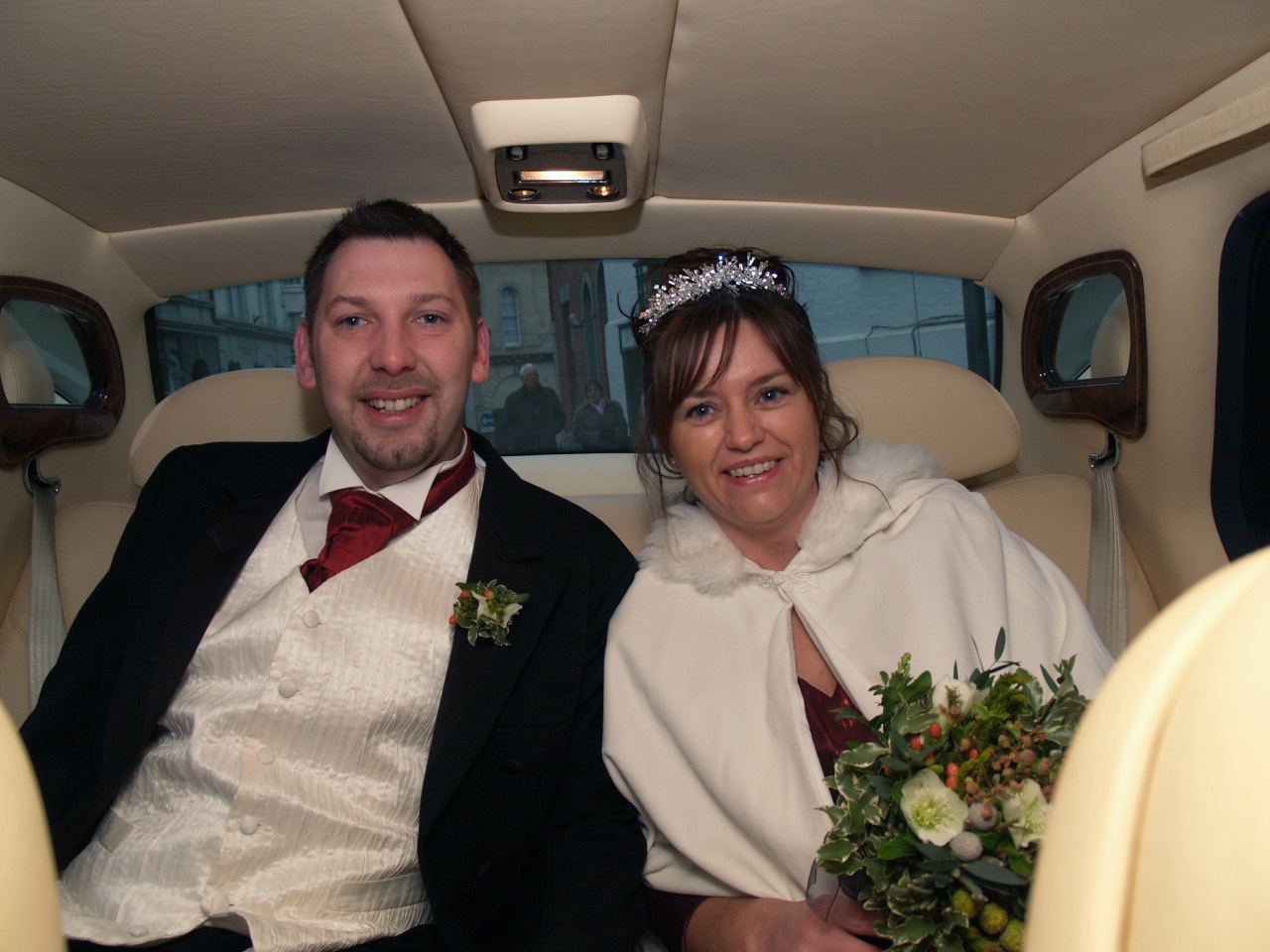 A newly married couple in the wedding car