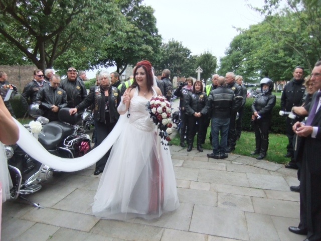 A bride surrounded by biker friends