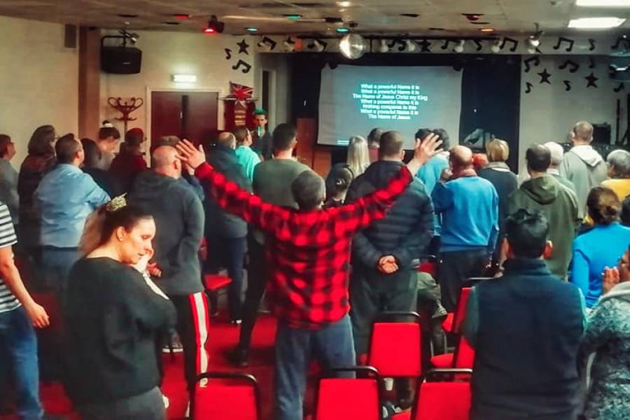 People worshipping in a hall