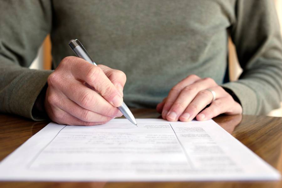 Person signing a form