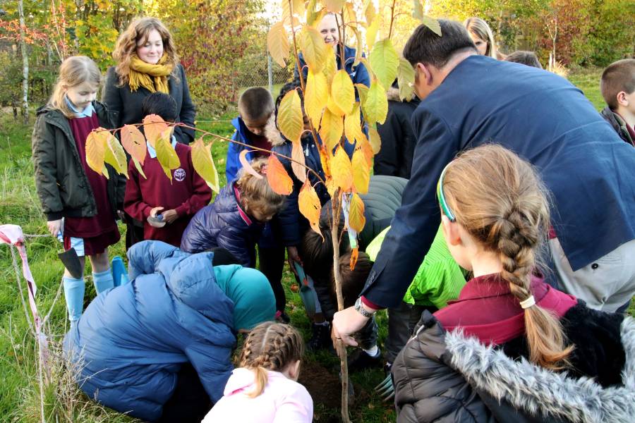 Bishop Graham Usher tree planting with school children
