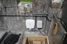 Wireless broadband infrastructure in the form of wires and boxes concealled within the tower of St Michael's church, Brent Tor.