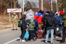 A group of refugees prepare to cross the border from Uzhhorod in Ukraine to Vyšné Nemecké in Slovakia