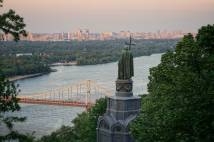 Ukraine's capital Kyiv is shown from a hill side with a statue of Saint Volodymyr 