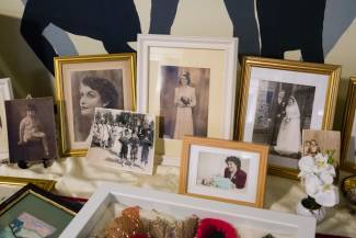 Close up of a display of old photos capturing different special moments throughout a lady's life