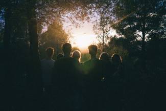 A group of people looking at a sunrise.