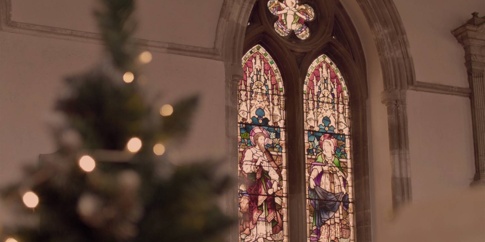 Stained Glass window with a Christmas tree in the foreground