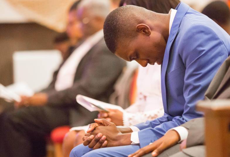 hombre rezando en la iglesia