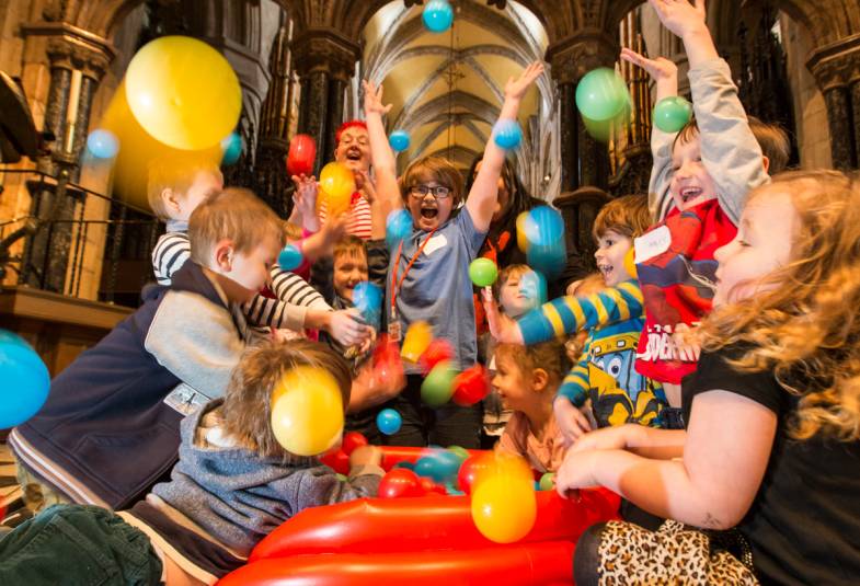 children play in ball pool inside cathedral 