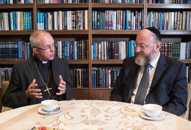 Archbishop Justin Welby and Chief Rabbi having tea at table 