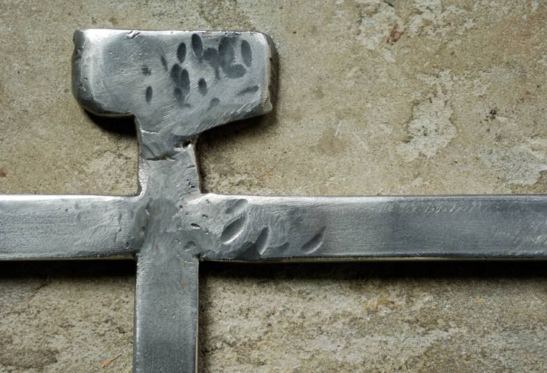 Close up of a processional cross made of metal