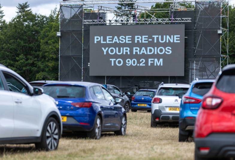 Cars are told to tune their radios to a FM frequency on a big cinema screen