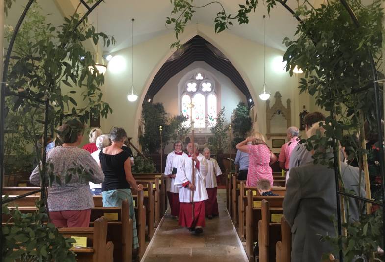 A service is conducted with trees in a church 