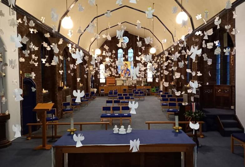 Knitted angels appear in a church nave