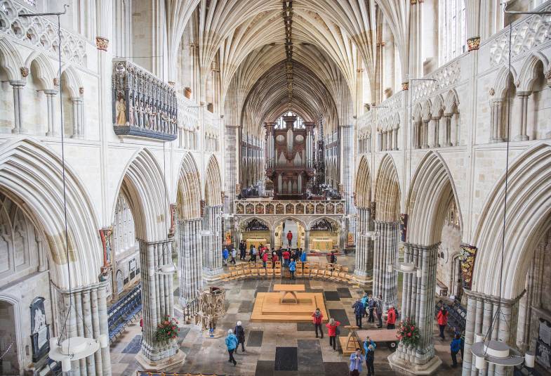 Exeter Cathedral is shown with the organ loft in the background of the nave