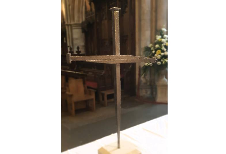Cross of Nails made of large metal nails on a plinth on the altar
