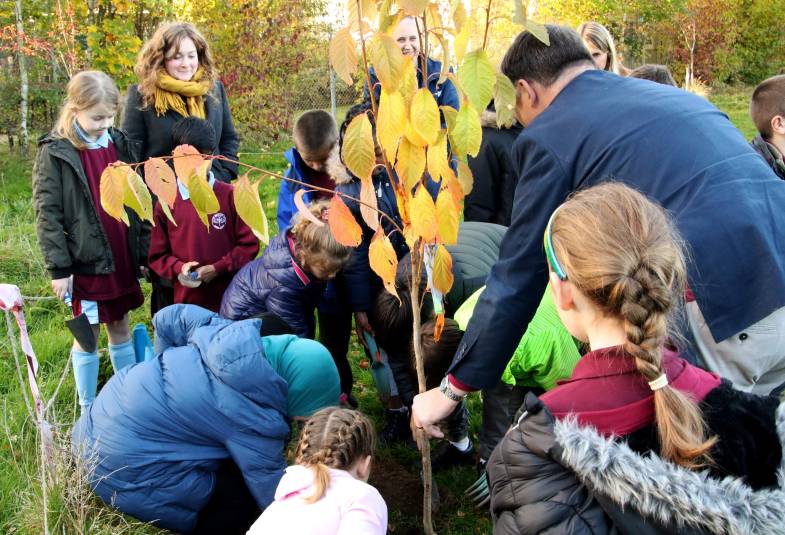 Bishop Graham Usher tree planting with school children