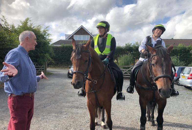 Rev Richard Allen with two visitors to his outdoor church on horseback