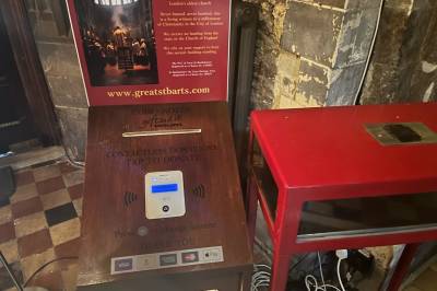 A close up of the contactless giving machine in St Barts church London
