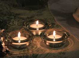 Three lit tealight candles