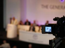 Film camera pointing at stage for General Synod 
