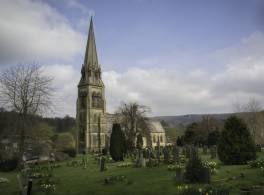 Exterior view of St Peter's church, Edensor and graveyard