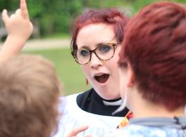 Female clergy member reacting to child 