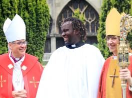 new clergy member with a bishop standing either side 