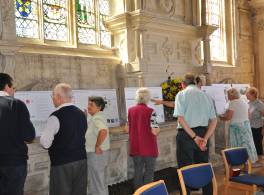 People looking at information panels of the church's development plans