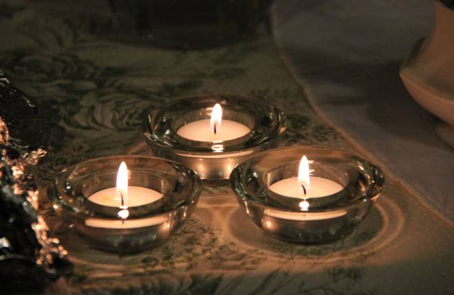 Three lit tealight candles