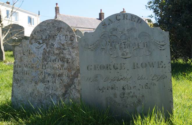 Two old graves in graveyard with tall grass