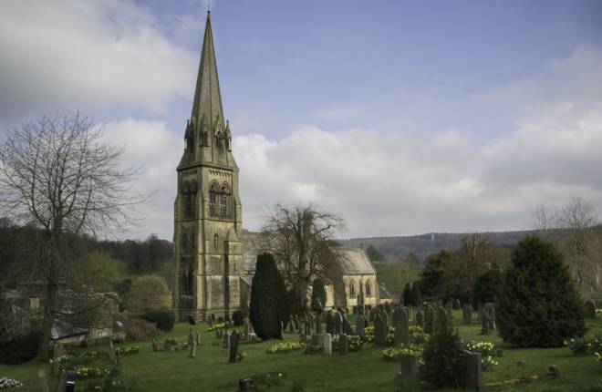Exterior view of St Peter's church, Edensor and graveyard