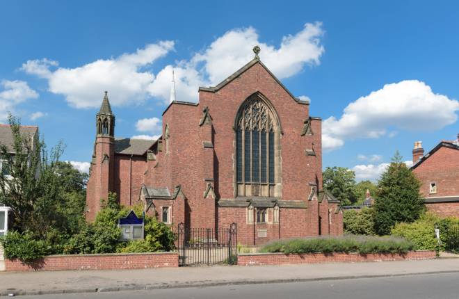 Outside view of brick church, sunny sky