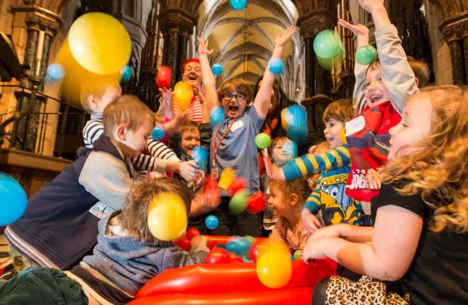 children play in ball pool inside cathedral 