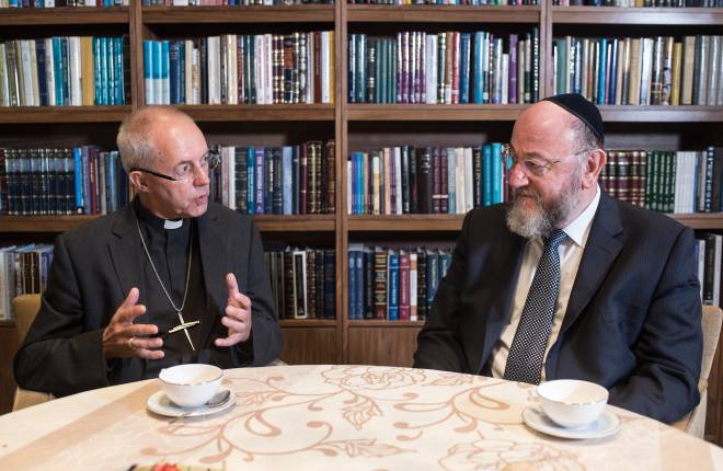 Archbishop Justin Welby and Chief Rabbi having tea at table 