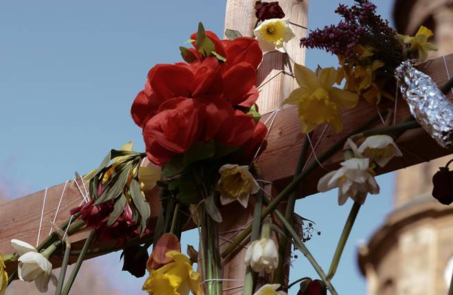 A cross with flowers on at Easter