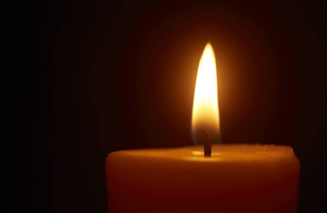 A close up shot of the top of a lit candle.