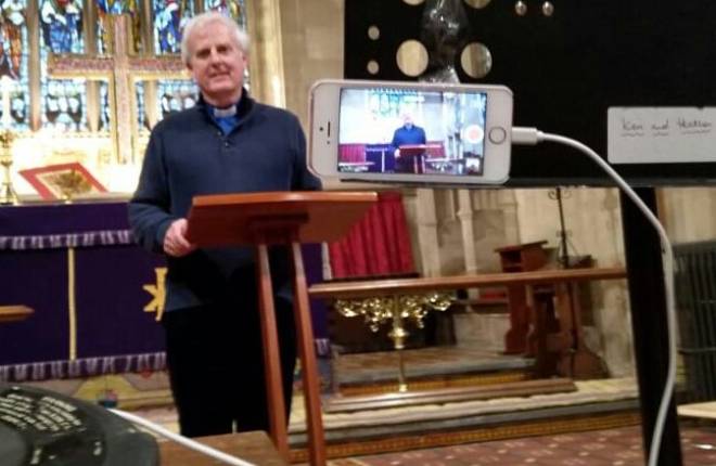 The vicar records his surface on his iPhone 