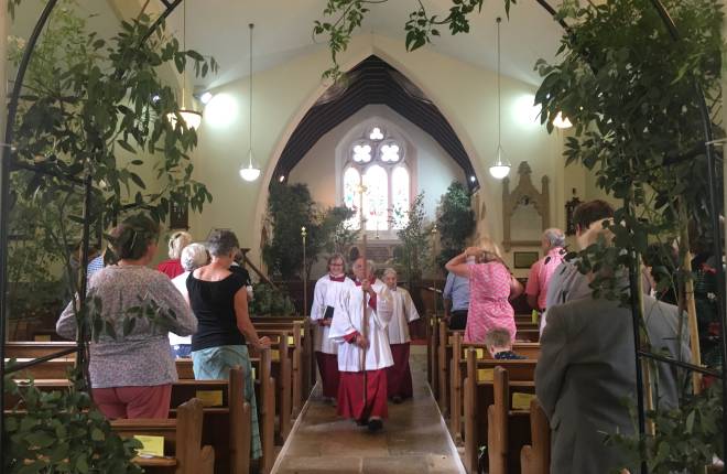 A service is conducted with trees in a church 