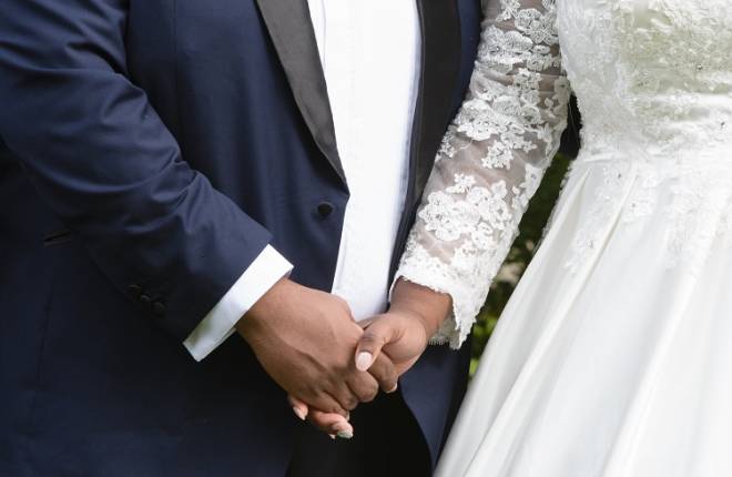 A close-up of a couple holding hands