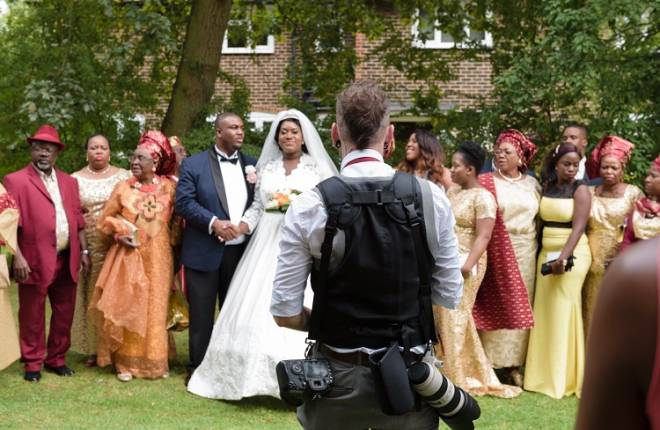 A wedding photographer setting up a group shot