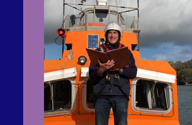 Rev Richard Allen on a life boat holding open a book