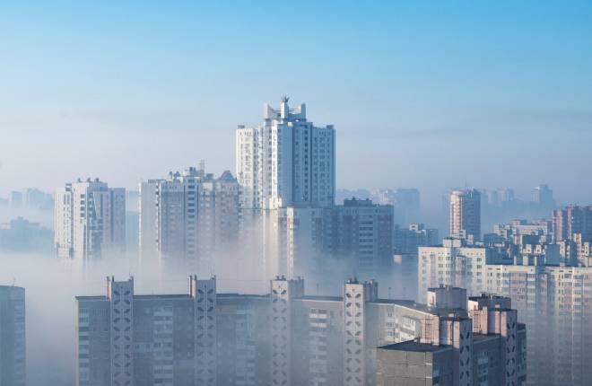 White fog hands over Kyiv or Kiev in Ukraine with high rise blocks of flats appearing